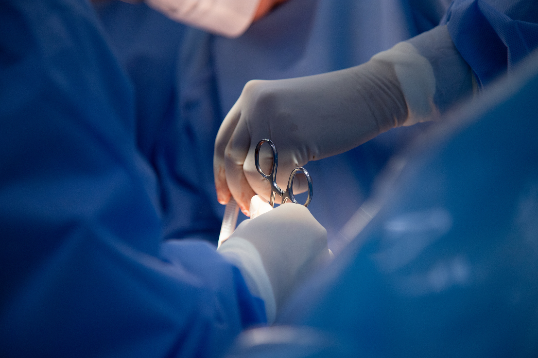 Medical team of surgeons in hospital doing a surgery